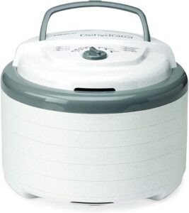 Stackable electric dehydrator used in off-grid food preservation to dry fruits, vegetables, and jerky